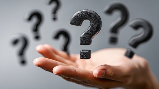 A hand cradles floating question marks against a blurred gray backdrop