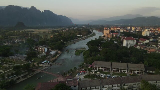 Aerial panoramic view of Vang Vieng city surrounded by limestone karst mountains, Laos.