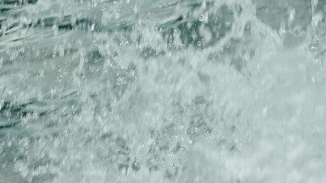 Cinematic Close-Up of Water Splashes and White Foam from a Fast Moving Boat, Crystal Clear Sea Waves and Droplets in Slow Motion