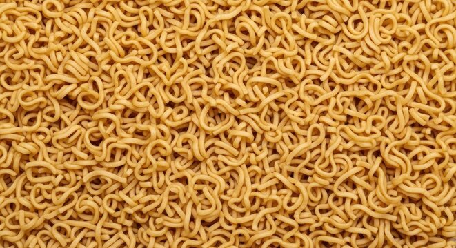 A large quantity of yellow noodles covers the entire frame. The noodles are tangled and densely packed, creating a textured surface.
