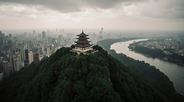 An aerial view captures the majestic Tower standing on a cliff overlooking the vast Yangtze River in the city of Jiujiang in China on a cloudy day
