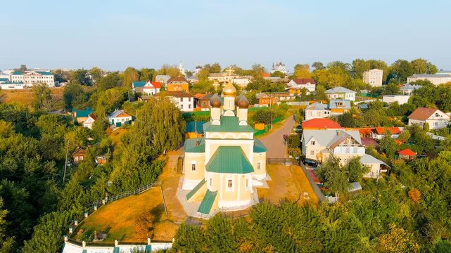 Murom, Russia. Annunciation and Trinity Monasteries, ornate white-stone cathedrals with carved kokoshniks and gilded domes, aerial summer view over the Oka River historic center. Drone footage