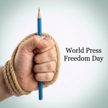 m World Press Freedom Day concept, hand tied with rope holding a pencil, censorship and free speech metaphor, journalism rights and human rights advocacy