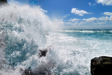 Obraz premium Atlantic waves crash powerfully against black lava rocks along the coast of Ajuy on Fuerteventura