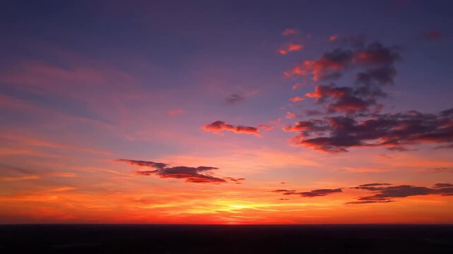 Vivid Colorful Sunset Sky - This stock video shows a breathtaking sunset featuring a colorful sky with layers of orange, pink, and purple hues.