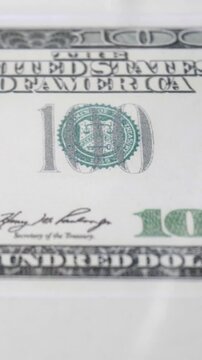 Drops of water and ripples with a hundred dollar bill growing economy concept