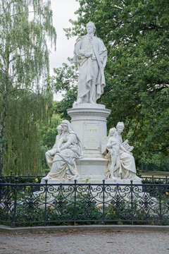 Marble statue of writer and statesman Johann Wolfgang vo Goethe in Tiergarten park, Berlin, Germany. On the foot allegorical figures of Drama, Lyric Poetry (and Amor), and Science 