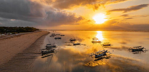 sunrise time,Outrigger boats moored on the coast of Bali © PENG