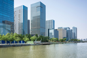 Fototapeta premium Stunning Urban Skyline Reflected in Serene Waterfront at Midday