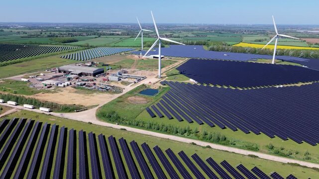 Aerial drone view of a renewable energy generation facility combining wind and solar power UK