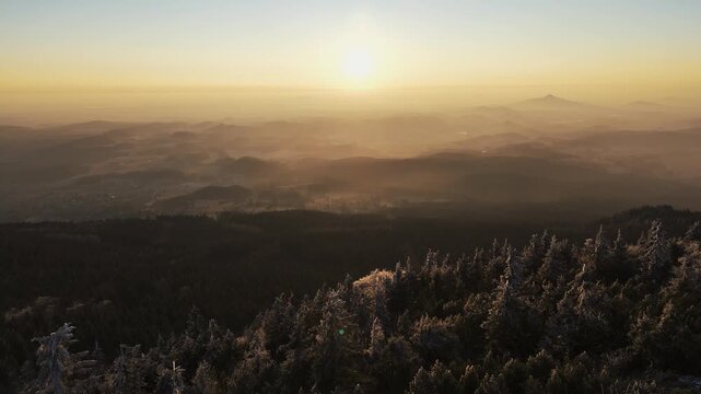 Sunset Landscape Over Misty Mountains and Frosty Coniferous Forest in Liberec Czech Republic