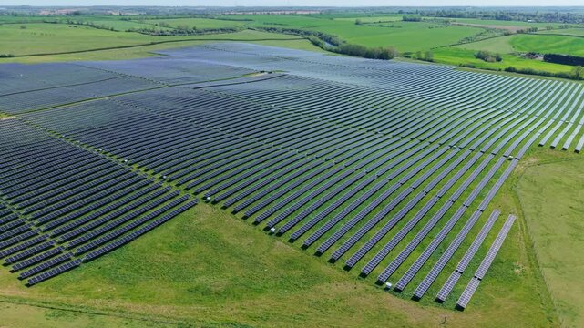 Aerial view of a utility scale solar energy farm contributing to the national grid infrastructure