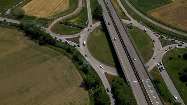 Aerial View of Highway Interchange: An aerial shot of a bustling highway interchange, showcasing the complex interplay of roads, bridges, Pantigliate, Lombardy, Italy,