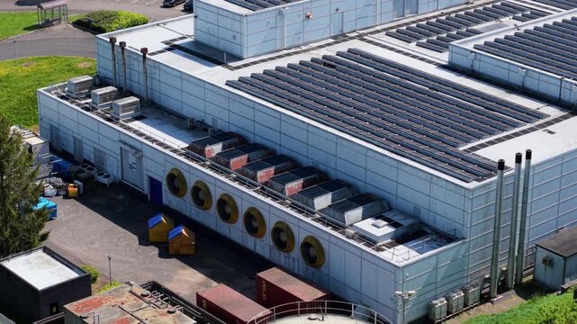 Close up aerial drone view of a large modern data center building with ventilation cooling systems on an industrial estate UK