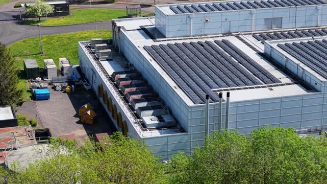 Close up aerial drone view of a large modern data center building with ventilation cooling systems on an industrial estate UK