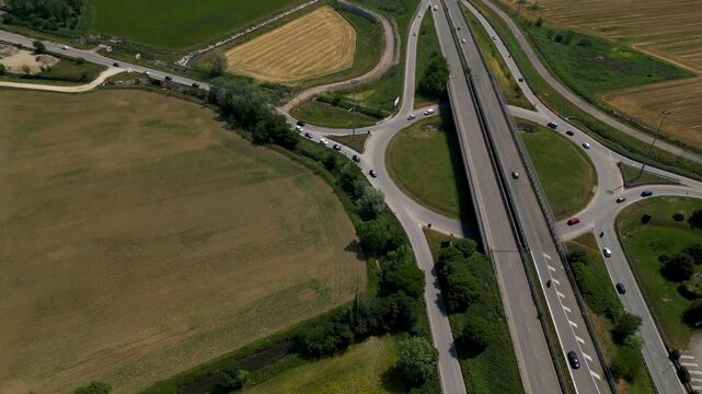 Aerial Highway Network: An expansive network of elevated roads and intersecting cloverleaf interchanges stretches across a vast agricultural landscape.