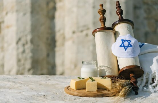 Traditional Jewish Torah Scrolls With Kippah and Dairy Foods Symbolizing Shavuot Celebration