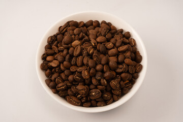 Fototapeta premium Coffee beans on a white background. Top view. Coffee beans texture.
