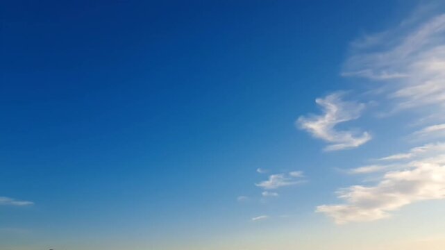 Bright blue sky with white wispy clouds at daytime
