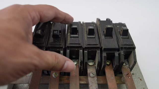 Hand handling old circuit breakers and electrical busbars