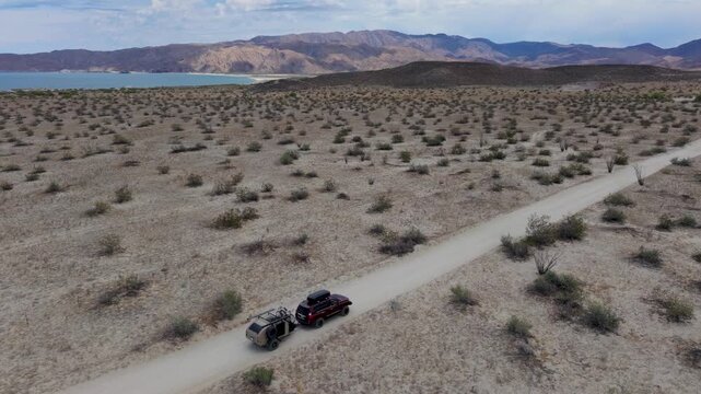 Watch an SUV pull a teardrop trailer through dirt roads in Baja California, Mexico while enjoying stunning aerial views of the landscape.