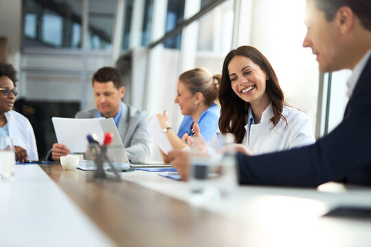Young female doctor discussing with businessman  during a meeting  in a clinic.