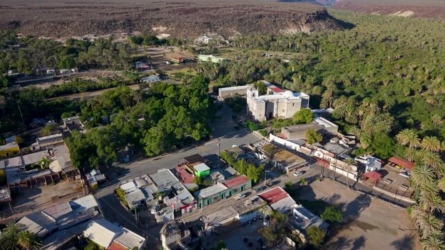 Aerial shots show the Mission Church and the town of San Ignacio, highlighting the landscape and buildings in Baja California, Mexico.