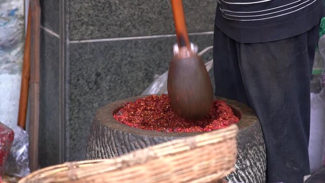 4K Slow-motion real shot of traditional pounding chili powder, Gangu chili from Gansu