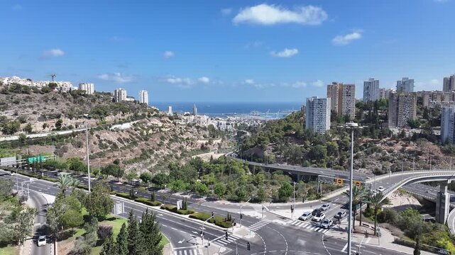 Scenic aerial view of Haifa city valley and modern high-rise buildings leading to the Mediterranean Sea and port