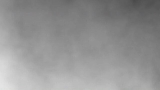 Abstract flowing grayscale smoke or fog animation creating a soft and moody background texture.
