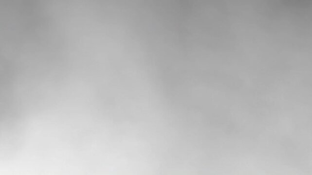 Abstract grayscale background with soft flowing smoke and fog textures creating a dynamic monochrome animation.