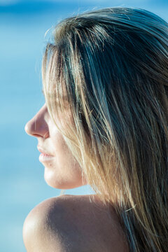 Young woman with blonde hair looking away