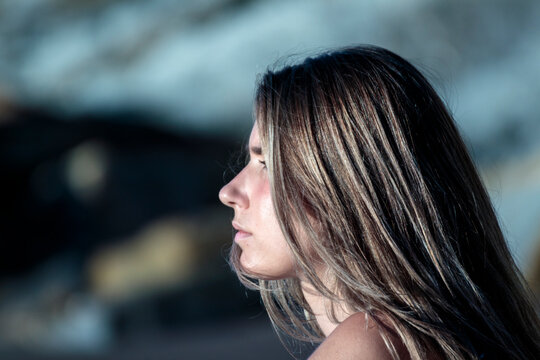 Young woman side profile thinking outdoors