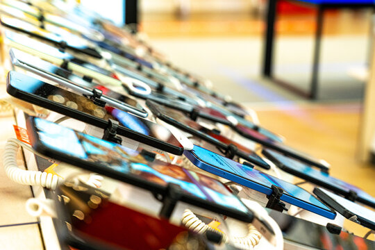 A Display of Modern Smartphones Showcasing Various Colors, Designs, and Features in a Retail Environment, Captivating Technology Enthusiasts and Shoppers