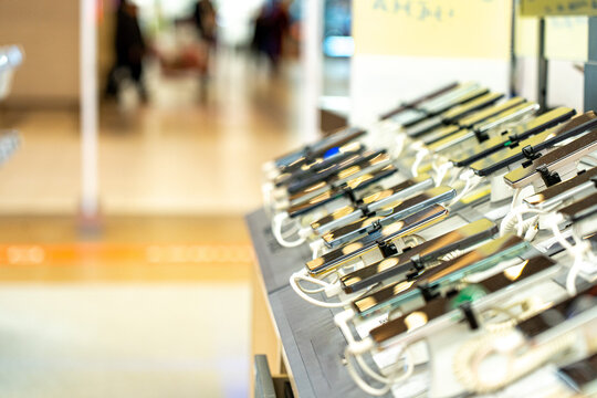 A Colorful Display of Modern Smartphones Arranged Neatly on a Retail Counter, Showcasing Various Models and Features for Customers to Explore