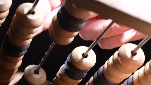 Macro view of vintage wooden abacus beads on rods representing counting calculation education finance and business accounting concept