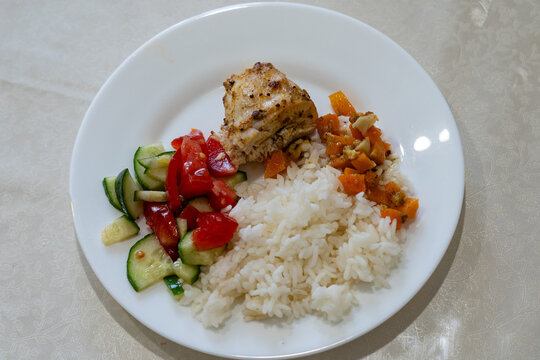A Wholesome Plate Featuring Grilled Chicken, Steamed Rice, and Fresh Vegetables for a Balanced Meal | Nutritious and Delicious