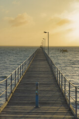 Fototapeta premium Pier extending into the ocean at Ceduna, Australia during sunset