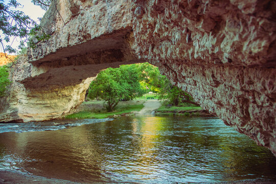Low angle upward view beneath a natural rock arch bridge