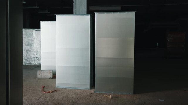 Ventilation duct sections prepared for installation inside parking structure