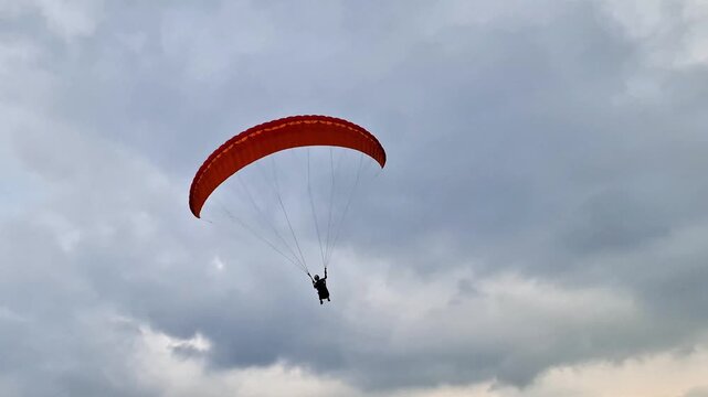 Malang, Indonesia - 3 May, 2026: Establishing Shot of Paragliding Launch Site on Mountain Cliff Overlooking Vast City and Farmland