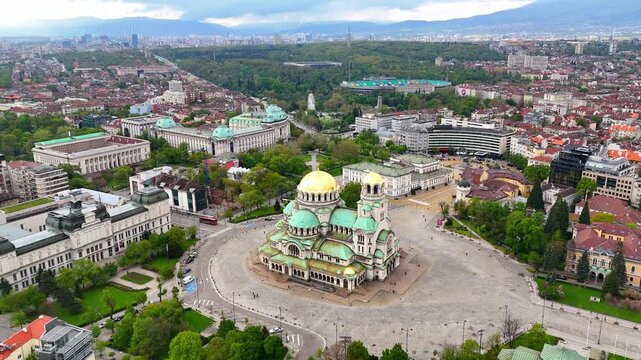 Aerial view of the majestic Alexander Nevsky Cathedral in Sofia. Stunning architecture and vibrant colors. Breathtaking drone view of the cityscape and the cathedral. Bulgaria	
