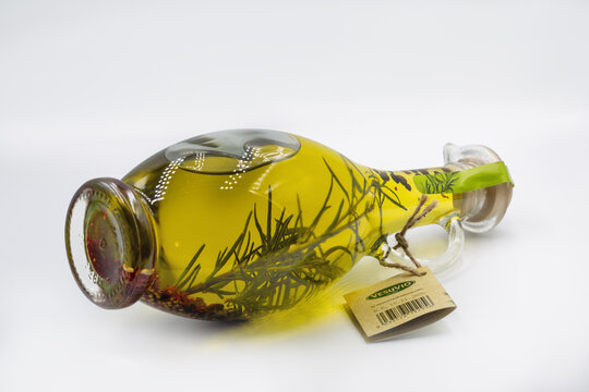 Gourmet Olio di Oliva glass bottle with rosemary and spices.