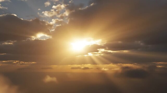 Dramatic golden sun rays breaking through dark clouds