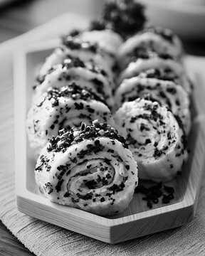 Gyeran mari egg food rolls with chives on a wooden plate
