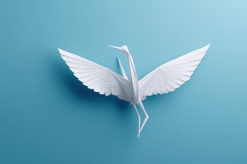 Naklejka premium Elegant White Origami Crane Bird Spreading Wings in Flight Against a Soft Blue Background