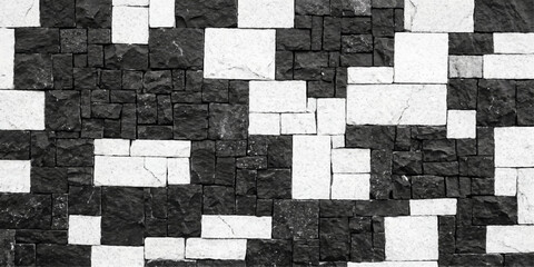 A unique and captivating wall, constructed from contrasting black and white stones arranged in a visually striking pattern. for web, ui, branding, art, design, background etc. © Midul