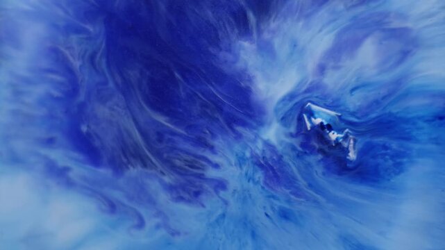 Paint drop explosion. Acrylic spill. Blue violet white enamel mixing spreading abstract background. Blur color art steam blend dye.