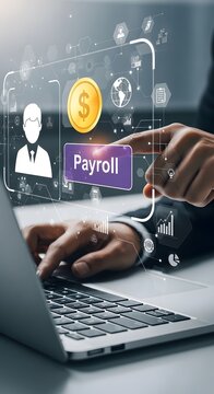 Hands on laptop with payroll and finance graphics
