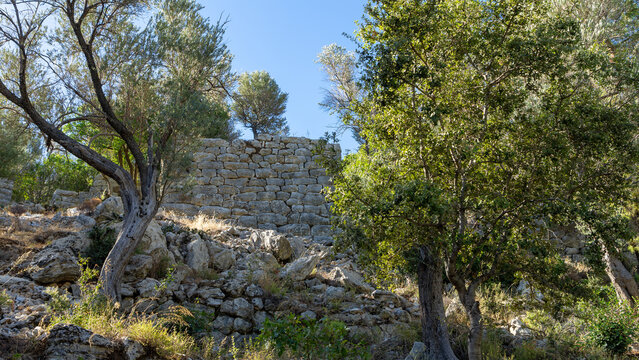 Stone wall in ancient city Amos near town or village of Turunc, Turkey. It was located in Rhodian Peraia in Caria on Mediterranean coast